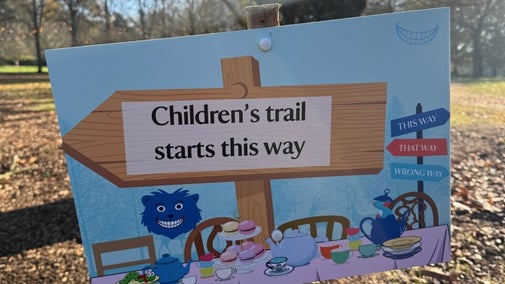 Alice's Christmas in Wonderland at Polesden Lacey 2025: a blue wooden sign reading 'Children's trail starts this way'